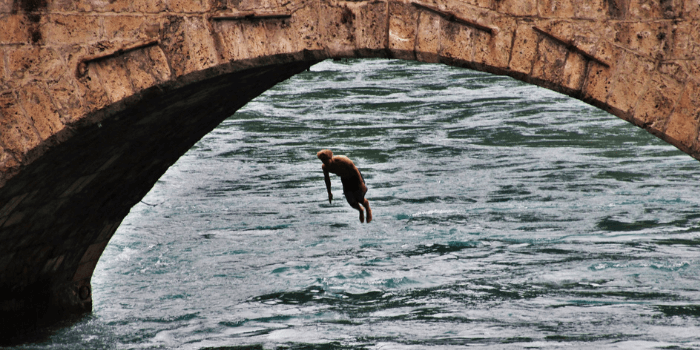 Mann springt von Brücke in den Fluss